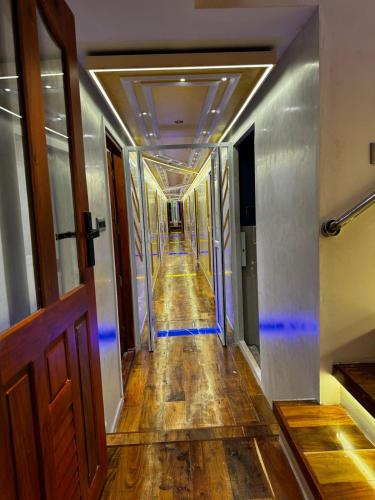 an empty hallway with blue lights in a building at Dreams Spectrum Luxury houseboat in Alleppey