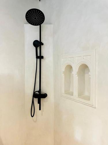 a black light on a wall next to a window at Stopover Guest House and Restaurant in Lamu