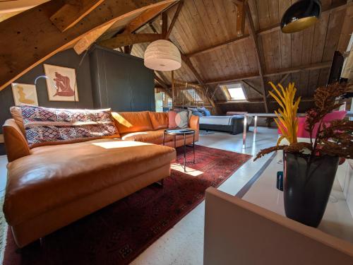 a living room with a couch and a table at Hofstede Prinsland in Kortgene