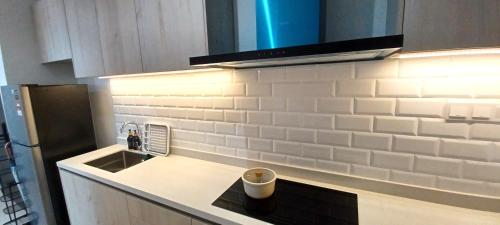 a kitchen with a sink and a counter top at LS Iconic Regency #Queensbay Mall#FIZ#Airport in Bayan Lepas