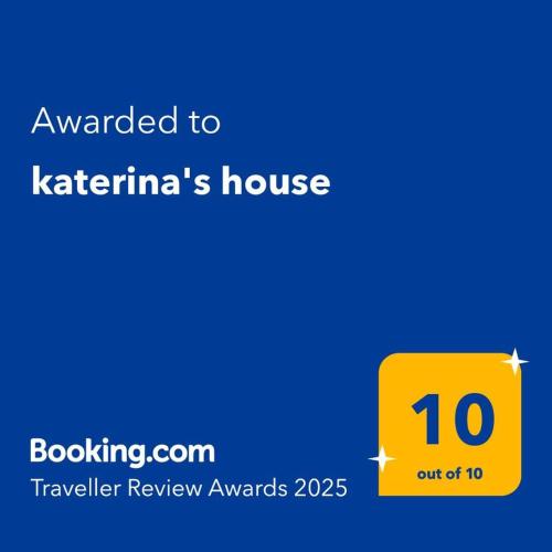 a yellow sign that reads awarded to katerinas house at katerina's house in Khónai