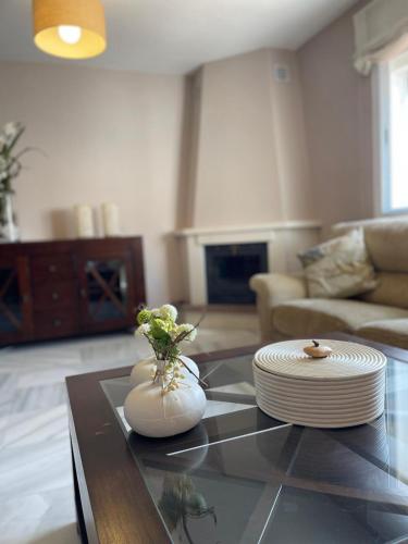 a living room with a table with plates on it at Terrasol Chalet en Torre Del Mar in Torre del Mar