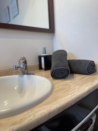 a bathroom counter with a sink and towels on it at Terrasol Chalet en Torre Del Mar in Torre del Mar