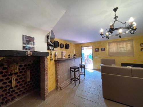 a room with a fireplace and a bar in a kitchen at Terrasol Chalet en Torre Del Mar in Torre del Mar