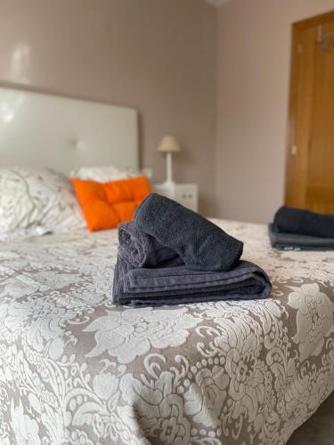 a pile of towels sitting on top of a bed at Terrasol Chalet en Torre Del Mar in Torre del Mar
