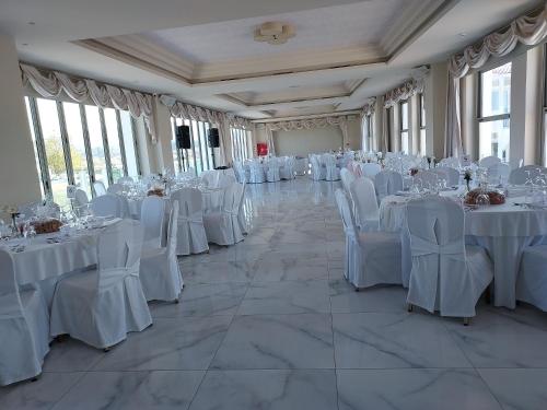 a banquet hall with white tables and chairs at Zante Park Resort & Spa BW Premier Collection in Laganas