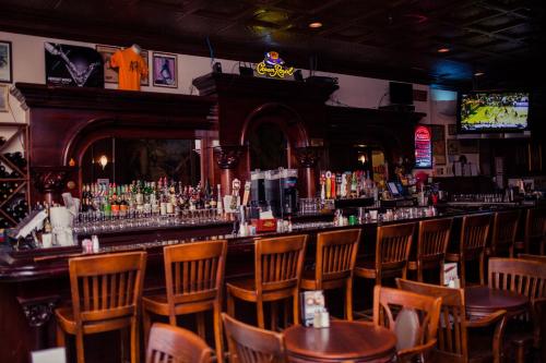 a bar in a restaurant with chairs and a counter at Gilmore Hotel, Trademark Collection by Wyndham in Ketchikan