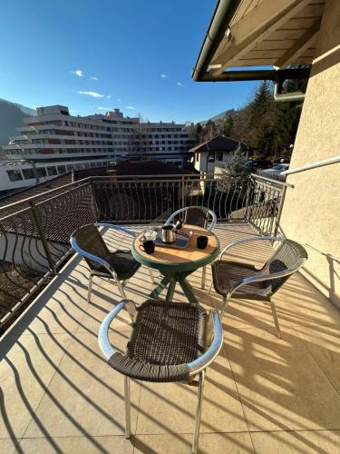 a patio table and chairs on a balcony at Premium Apartment in Fojnica