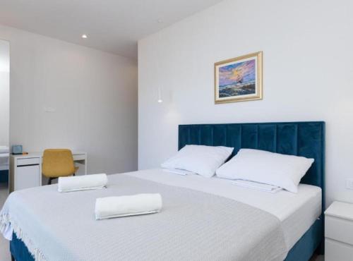 a bedroom with a large bed with two white pillows at Luxury Villa Navis in Rogotin