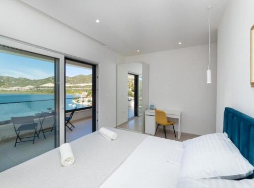 a bedroom with a bed and a view of the ocean at Luxury Villa Navis in Rogotin