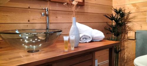 a bathroom with a sink and a vase on a counter at Nancy Gare Centre Parking in Nancy
