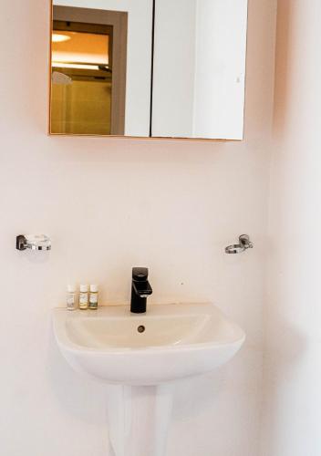 a white sink in a bathroom with a mirror at Hotel Dakhla Club & SPA in Dakhla