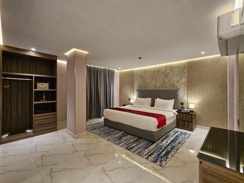 a bedroom with a large bed in a room at Royal Plaza Hotel in Duqm