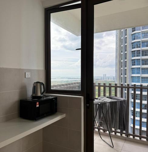 a bathroom with a window and a view of the city at New l Seaview l Bali Residence l Kids Tent l 8 pax l Water Theme Park l Netflix in Tranquerah