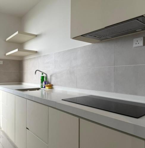 a kitchen with white cabinets and a sink at New l Seaview l Bali Residence l Kids Tent l 8 pax l Water Theme Park l Netflix in Tranquerah