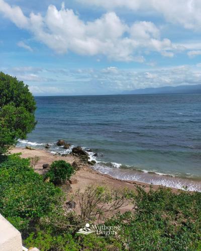 a view of the ocean from a bluff at Wuthering Heights Bed & Breakfast by the Sea in Dumaguete