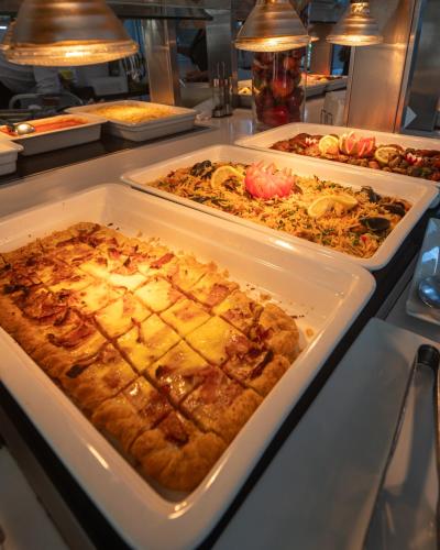 a buffet with several trays of food on a table at Zante Park Resort & Spa BW Premier Collection in Laganas