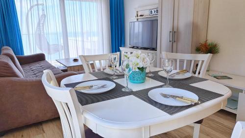a dining room with a white table and chairs at Your Home Montenegro in Dobra Voda