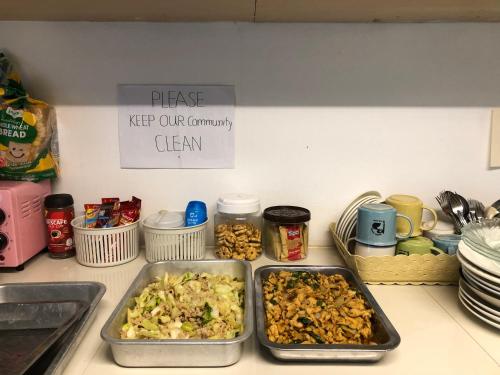 a kitchen counter with two trays of food on it at Baiyok House in Ban Ai Dao