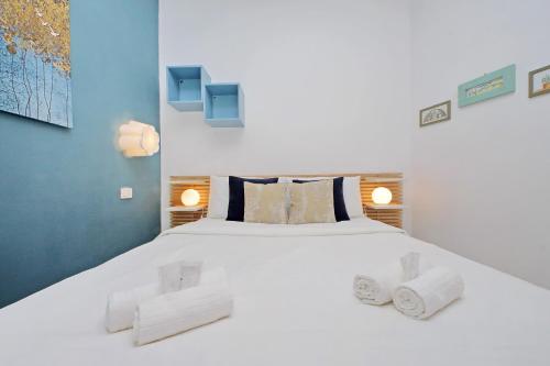 a bedroom with a large white bed with towels on it at San Paolo's apartment in Rome