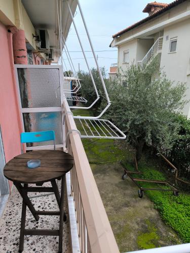 a chair and a table on a balcony at Hotel Almira in Agia Triada