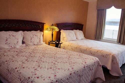 a bedroom with two beds and a window at Gilmore Hotel, Trademark Collection by Wyndham in Ketchikan