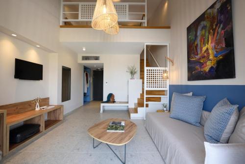 a living room with a couch and a table at Falena Luxury Rooms in Kalyves Poligirou