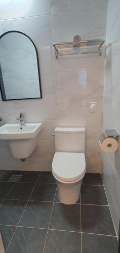 a bathroom with a white toilet and a sink at High-Quality House Ocean view in Tongyeong