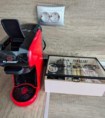 a red and black blender next to a box at DiP HOME APARTMENTS in Pomorie