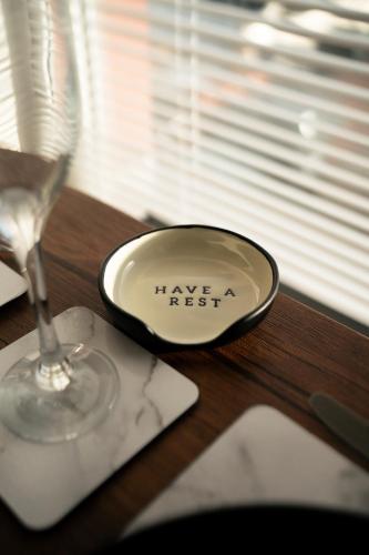 a plate on a table next to a wine glass at Stunning 2 Bedroom Ground Floor Sea View Apartment in Llandrillo-yn-Rhôs