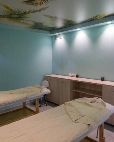 a hospital room with two beds and a blue wall at Zante Park Resort & Spa BW Premier Collection in Laganas