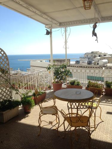 a patio with a table and chairs on a balcony at Hotel Villa Delle Palme in Positano in Positano