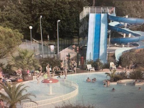 - un groupe de personnes dans une piscine avec toboggan dans l'établissement Chalet Bassin d'Arcachon Parc Résidentiel Loisirs, à La Teste-de-Buch