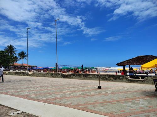 a beach with a group of people on the beach at Casa de Praia - Pe na Areia in Mongaguá