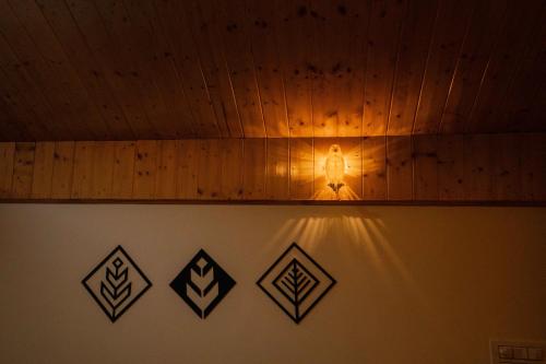 a light on a wall with a wooden ceiling at Mellow- A Himalayan Home in Haripūr