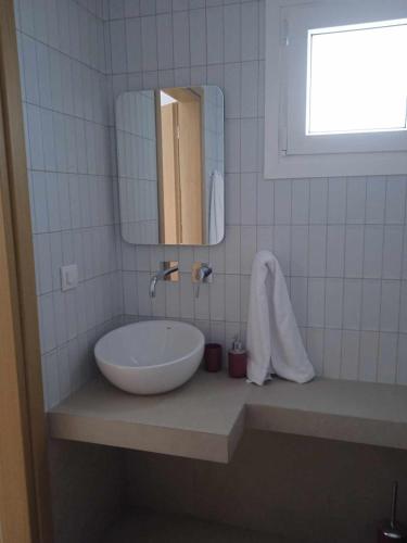 a bathroom with a sink and a mirror at Avra Studios in Myrties