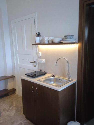 a kitchen with a sink and a white door at Avra Studios in Myrties
