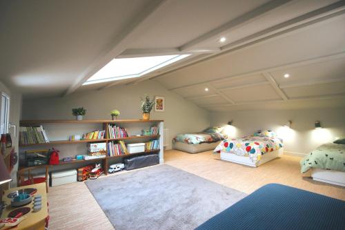 a bedroom with two beds and a book shelf at Villa 3 Mats in Dolus-d'Oléron