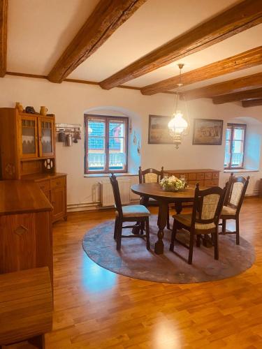 a dining room with a table and chairs at Apartmány Selský dvůr in Třebeň