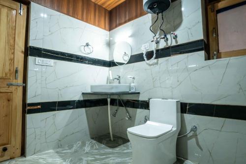a bathroom with a toilet and a sink at Mellow- A Himalayan Home in Haripūr