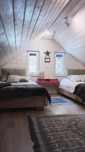 a bedroom with two beds in a attic at Wilkovo Roztocze in Hutków