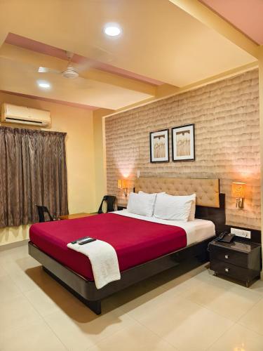 Ένα ή περισσότερα κρεβάτια σε δωμάτιο στο Hotel Vaishnavi