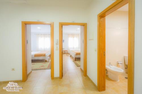 a bathroom with two doors and a bathroom with a toilet at Casas Campo Cimo da Quinta in Miranda do Douro