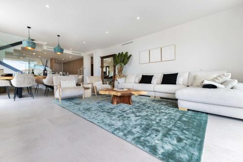a living room with a couch and a table at Casa Sol Luxury Rooftop Penthouse Gym Spa Pools in Marbella