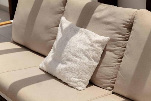 a white pillow sitting on top of a couch at Casa Sol Luxury Rooftop Penthouse Gym Spa Pools in Marbella
