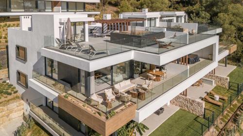 an aerial view of a house with a lot of glass at Casa Sol Luxury Rooftop Penthouse Gym Spa Pools in Marbella
