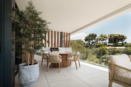 a dining room with a table and a large window at Casa Sol Luxury Rooftop Penthouse Gym Spa Pools in Marbella