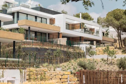 a large white building with a garden in front of it at Casa Sol Luxury Rooftop Penthouse Gym Spa Pools in Marbella