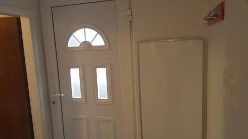 a white door with a window in a room at Love 2 Solkan in Nova Gorica