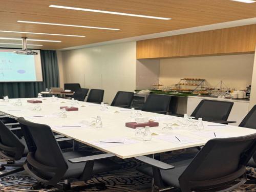 a large conference room with a large table and chairs at Novotel Jazan in Jazan